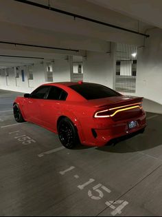 a red sports car parked in a parking garage