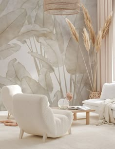 a living room filled with white furniture and walls covered in wallpapered plants next to a window