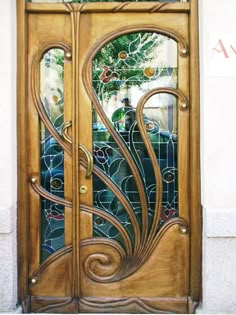 an ornate wooden door with glass panels