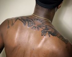 the back of a man with tattoos on his body