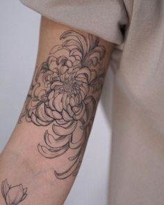 a woman with a flower tattoo on her arm