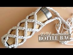 the bottle bag is made out of rope and wood