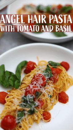 angel hair pasta with tomato and basil on a white plate, topped with spinach leaves