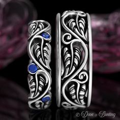 two silver rings with blue stones on them