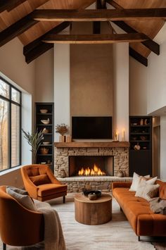 a living room filled with furniture and a fire place in the middle of the room