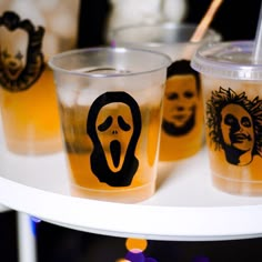 three cups with drinks decorated to look like faces