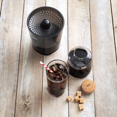 a cup of coffee and some cookies on a wooden table next to an air fryer