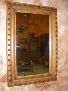 a large mirror hanging on the wall above a table