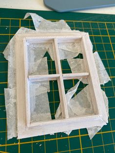 an unfinished window sitting on top of a cutting board