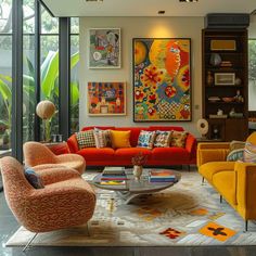 a living room filled with lots of furniture and paintings hanging on the wall above it