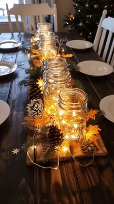 the table is set with mason jars and pine cones