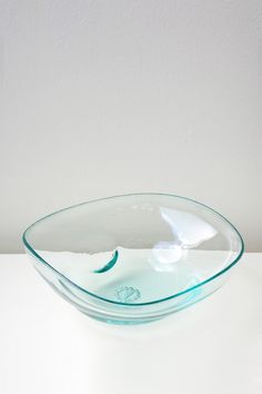 a glass bowl sitting on top of a white table