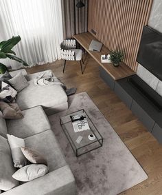 a living room filled with furniture and a flat screen tv on top of a wooden floor