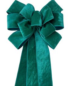 a large green bow tied on top of a white wall