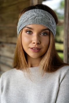 a woman wearing a headband and looking at the camera