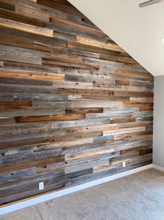 an empty room with wood paneling on the wall