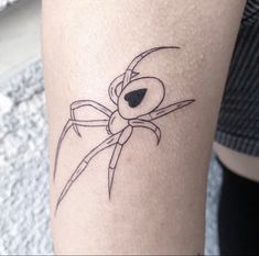 a spider tattoo on the leg of a woman