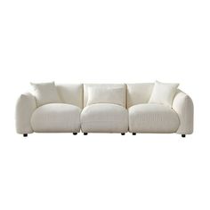 a white couch with four pillows on it