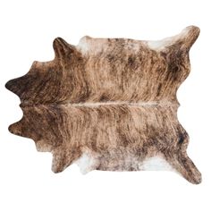 two brown and white sheepskin rugs laying on top of each other