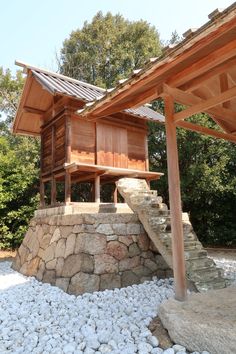 a wooden structure sitting on top of a pile of rocks