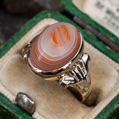 This unique and incredible vintage Mottled agate ring is crafted of 14k yellow gold and features a bezel set oval agate cabochon. The ring is currently a size 4.75. Luxury Cabochon Engagement Ring, Luxury Cabochon Ring For Engagement, Luxury Oval Dome Ring With Cabochon, Classic Agate Rings For Formal Occasions, Classic Agate Signet Ring For Formal Occasions, Elegant Agate Rings For Collectors, Unique Oval Signet Ring Collectible, Oval Agate Signet Ring With Polished Finish, Oval Agate Rings With Polished Finish