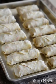 some dumplings are sitting on a baking sheet