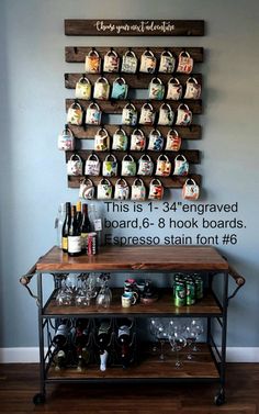 a bar cart with wine glasses and bottles on it in front of a wall display