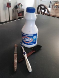 a toothbrush sitting on top of a table next to a bottle