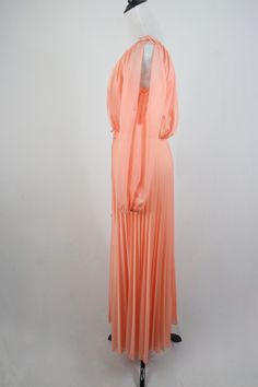 "1970s maxi dress. Peach colored light weight sheer polyester fabric on the outside and lined with an opaque nylon fabric. Long sleeves are unlined and are open from the shoulder to about the elbow with elastic at the wrists. Blousy top, elastic waist, and accordion pleated skirt. There is not a lot of stretch to the waist. Skinny fabric cord belt. Fastens down the back with a metal zipper. Only labels are a size 11/12, ILGWU, and dry clean only. Freshly laundered. (I have to laugh when polyeste Vintage Chiffon Maxi Dress For Spring, Flowy Peach Maxi Dress For Party, Peach Flowy Maxi Dress For Party, Summer Evening Maxi Dress In Peach, Summer Evening Peach Maxi Dress, 1970s Style Maxi Length Lined Dress, 1970s Style Lined Maxi Dress, Vintage Lined Maxi Dress For Party, Vintage Style Lined Maxi Dress For Party