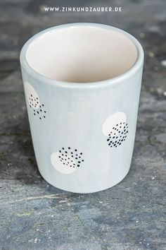 a white cup sitting on top of a table