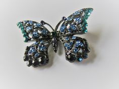 "A lovely and sparkly butterfly brooch in shades of blue and green (and gray and black). 1 5/8\" x 2 3/8\". It is very well made and in very good condition. Fully functional clasp. No name or hallmark. Nice spring and summer theme, and colors make it a year-round piece. For items shipped to places outside of the US, buyers pay all costs related to the import of the items, including customs fees and taxes." Sparkly Butterfly, Shades Of Blue Green, Patriotic Projects, Scarab Bracelet, Green And Gray, Summer Theme, Star Butterfly, Butterfly Brooch, No Name