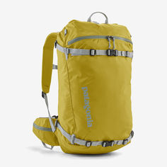 a yellow backpack sitting on top of a white floor