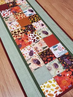 a patchwork table runner is on the floor