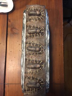 a metal tray that has some type of food in it on top of a wooden table