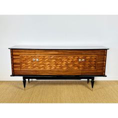 a large wooden cabinet sitting on top of a carpeted floor next to a wall