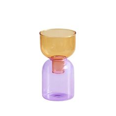 a purple and yellow glass vase sitting on top of a table