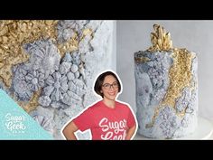 a woman standing in front of two large vases with gold leaf decorations on them