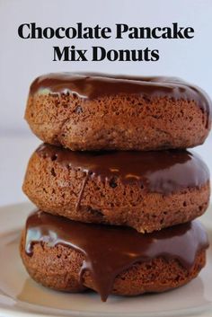 three chocolate donuts stacked on top of each other with the words easy chocolate donuts made with pancake mix