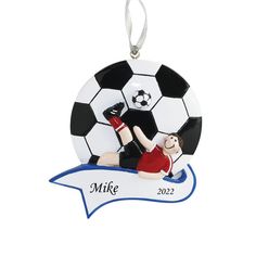 a personalized ornament with a soccer player kicking a soccer ball on it