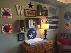 a baby's room decorated in patriotic colors and decor with stars on the wall