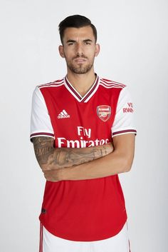 a man in a red and white shirt with his arms crossed