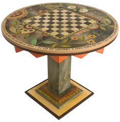 a small table with a chess board on it's center piece and flowers painted on the top