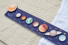 the solar system is displayed on a piece of paper with magnets attached to it