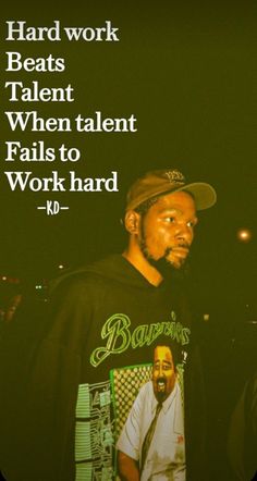 a man standing in front of a poster with the words work beats talent when talent falls to work hard