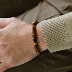 Return to the essentials. Essential for any contemporary man's jewelry assortment, these elastic stone bead bracelets are versatile enough to be worn individually or layered as preferred. - STONE: Tiger Eye (boosts confidence, aids harmony, enhances decision-making)- STONE SHAPE: Round- METAL COLOR: Brushed silver- METAL MATERIAL: 316L stainless steel- BRACELET TYPE: Elastic Stone Bead Bracelets, 99 Design, Gold Armband, Tiger Eye Bracelet, Tigers Eye Gemstone, Bracelet For Men, Bead Bracelets, Black Edition, Tiger's Eye