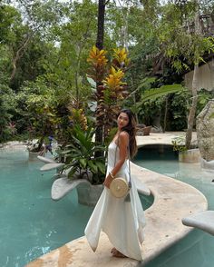 a woman standing in front of a pool