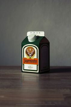 a carton of jagermeister coffee sitting on a wooden table next to a gray wall