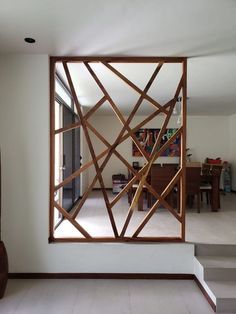 a mirror that is in the middle of a room with some stairs and tables behind it