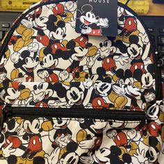 Brand New With Tag "Disney Mickey Mouse" Small Backpack Description: * Adorable Small Disney Mickey Mouse Backpack * Water Resistant And Durable Wipe Clean Polyurathane Material * East West Double Zippers Meet In The Middle For Easy Access * One Outside Zip Storage Pocket * Adjustable Shoulder Straps * Height: 11.5" ~ Width: 9" ~ Depth: 4 Gold Character, Mickey Mouse Backpack, Disney Bag, Small Backpack, Small Purse, East West, Purse Bag, Disney Mickey Mouse, Disney Mickey