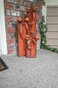 an orange wooden box with two bows on it sitting in front of a brick wall